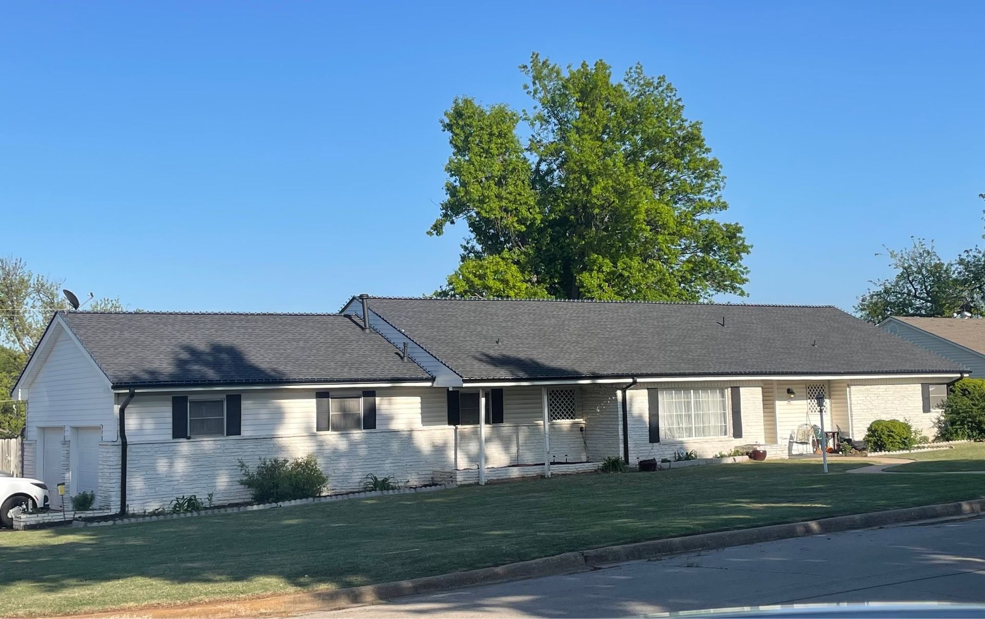 A large white house with a gray roof