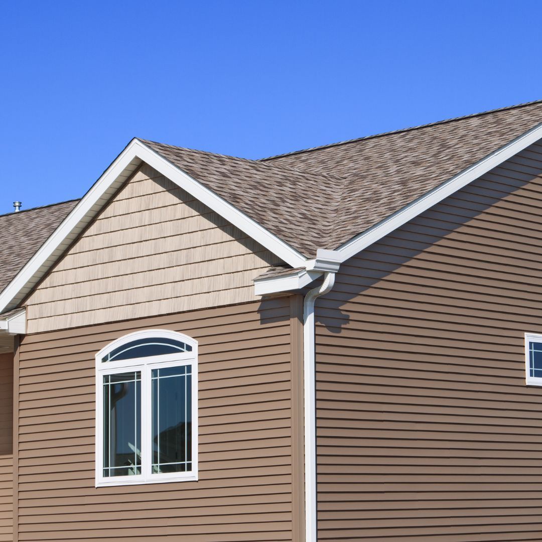 A brown house with a blue sky in the background
