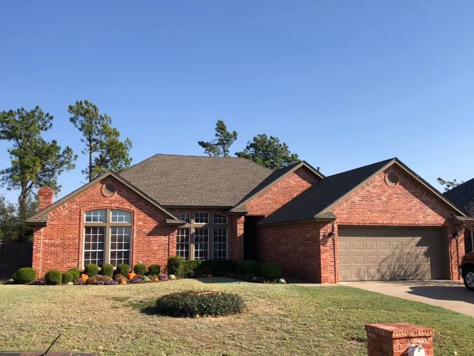 A brick house with a garage and a fire hydrant in front of it