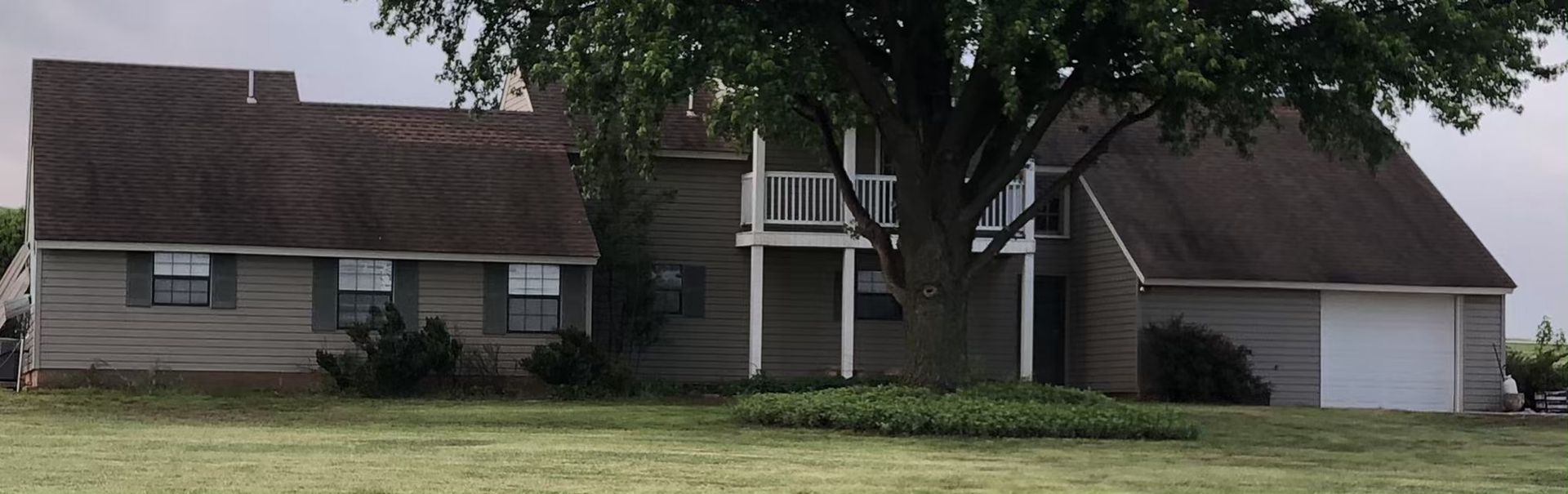 A house with a large tree in front of it