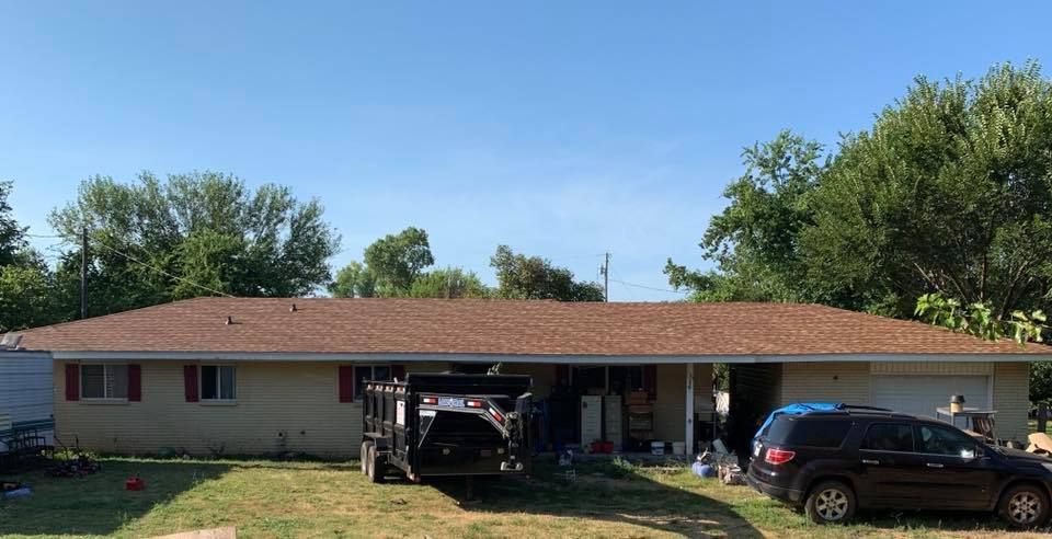 A house with a truck parked in front of it.