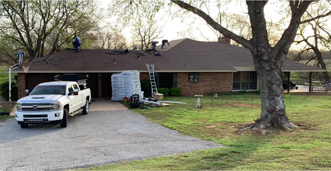 A white truck is parked in front of a house.