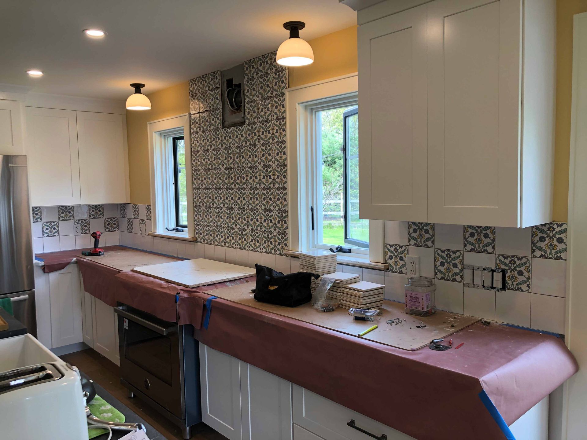 A Kitchen Is Being Remodeled With White Cabinets And Stainless Steel Appliances — Kingston, NY — T.I. Contracting
