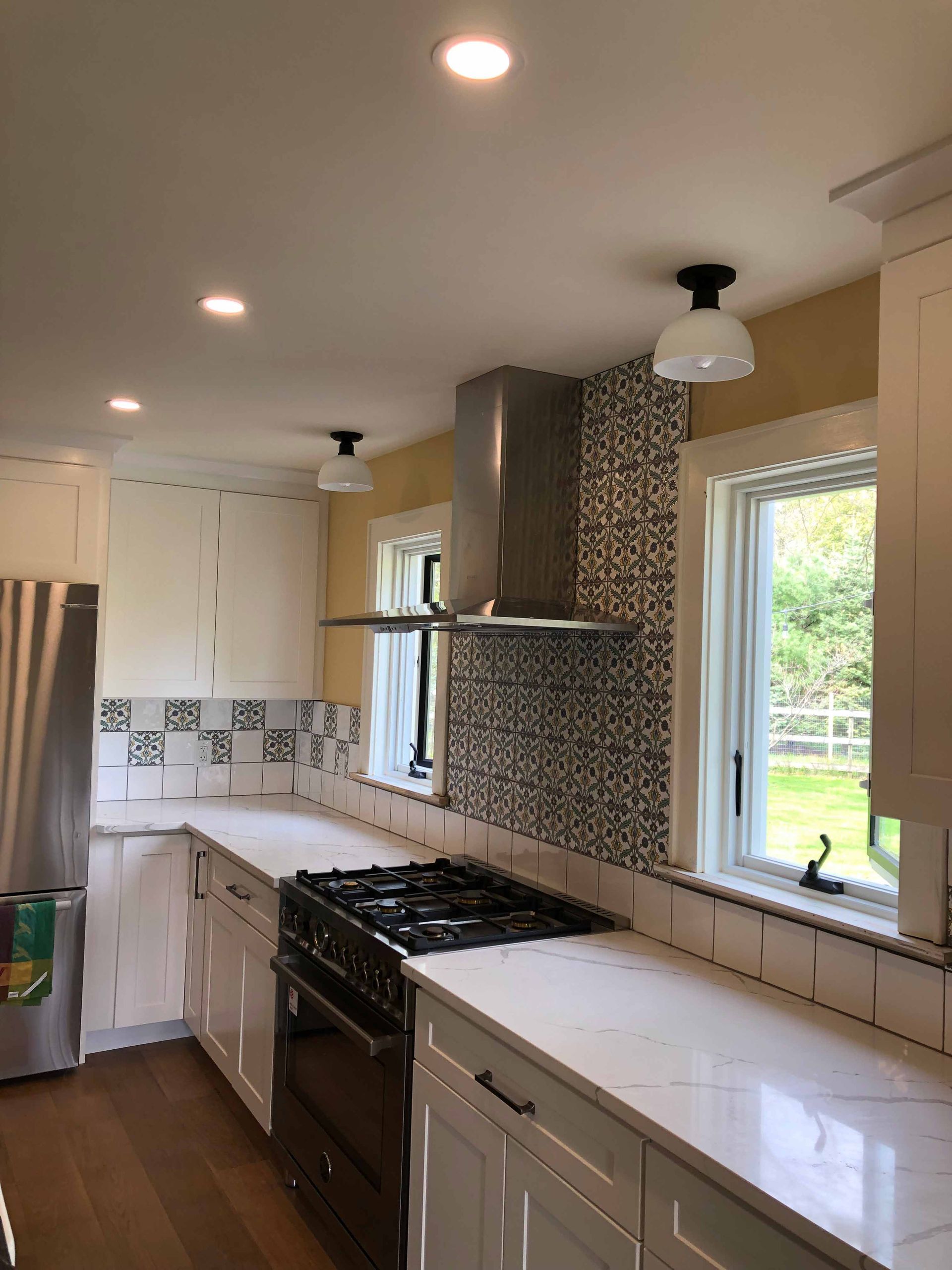 A Kitchen With White Cabinets And Stainless Steel Appliances — Kingston, NY — T.I. Contracting
