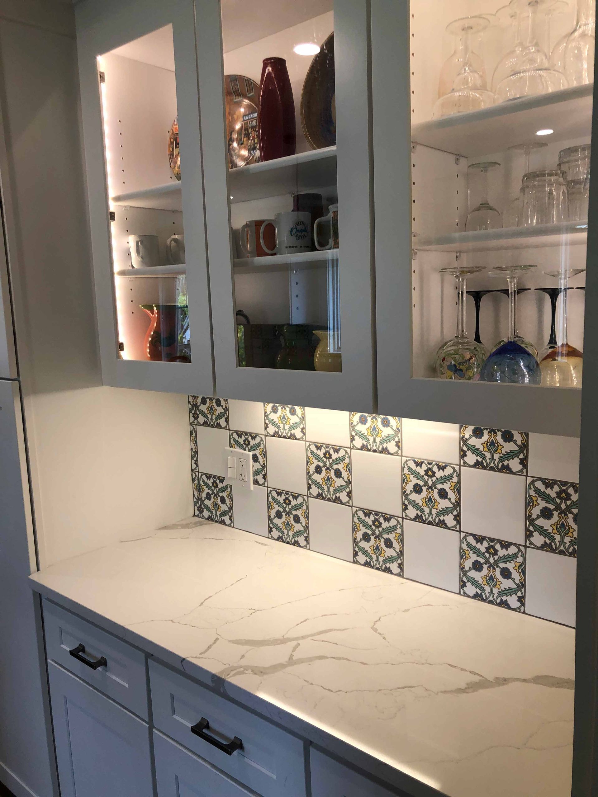 A Kitchen With White Cabinets , White Counter Tops , And Glass Doors — Kingston, NY — T.I. Contracting
