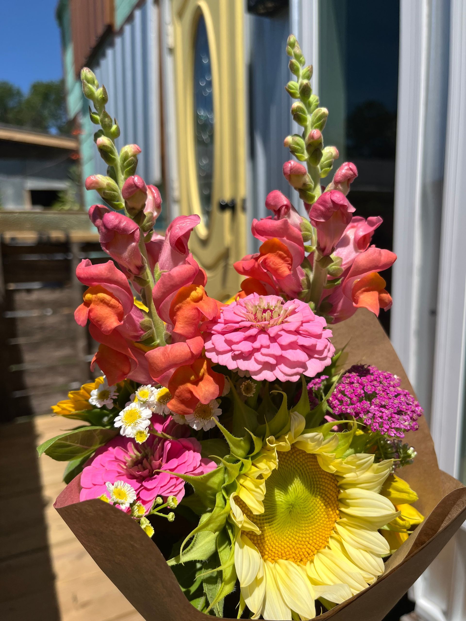 A bunch of colorful flowers are sitting on a table.