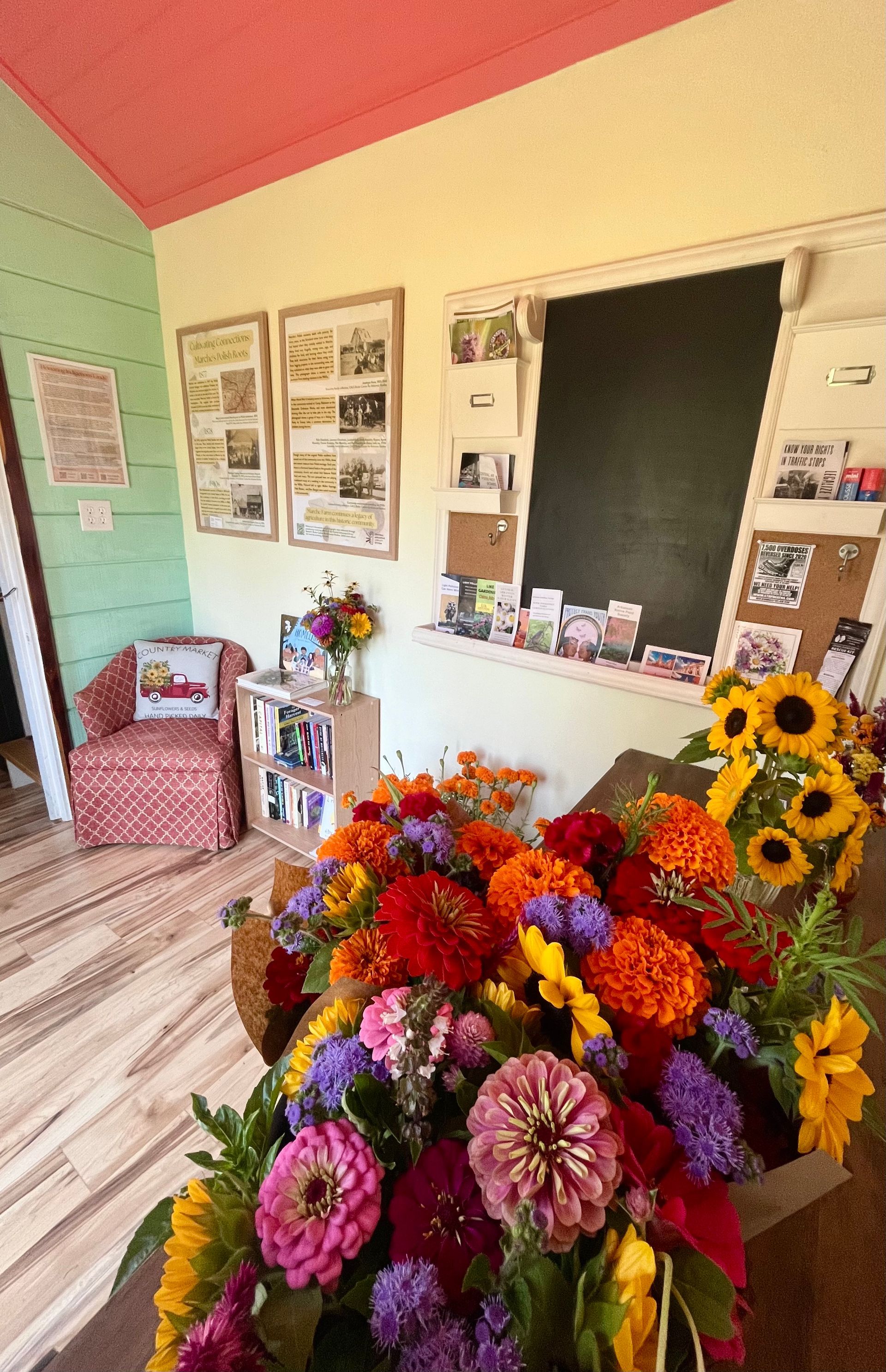 A bunch of flowers are sitting on a table in a room.