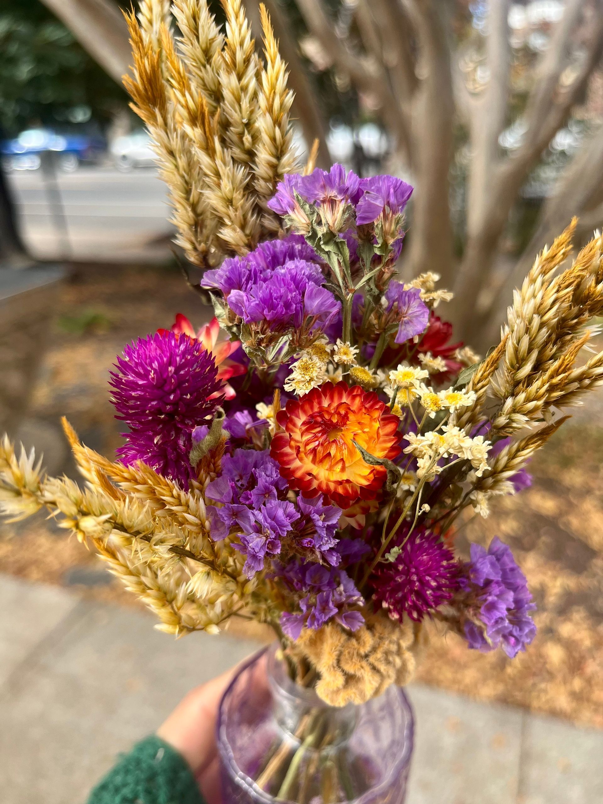 A bunch of flowers in purple vases on a table