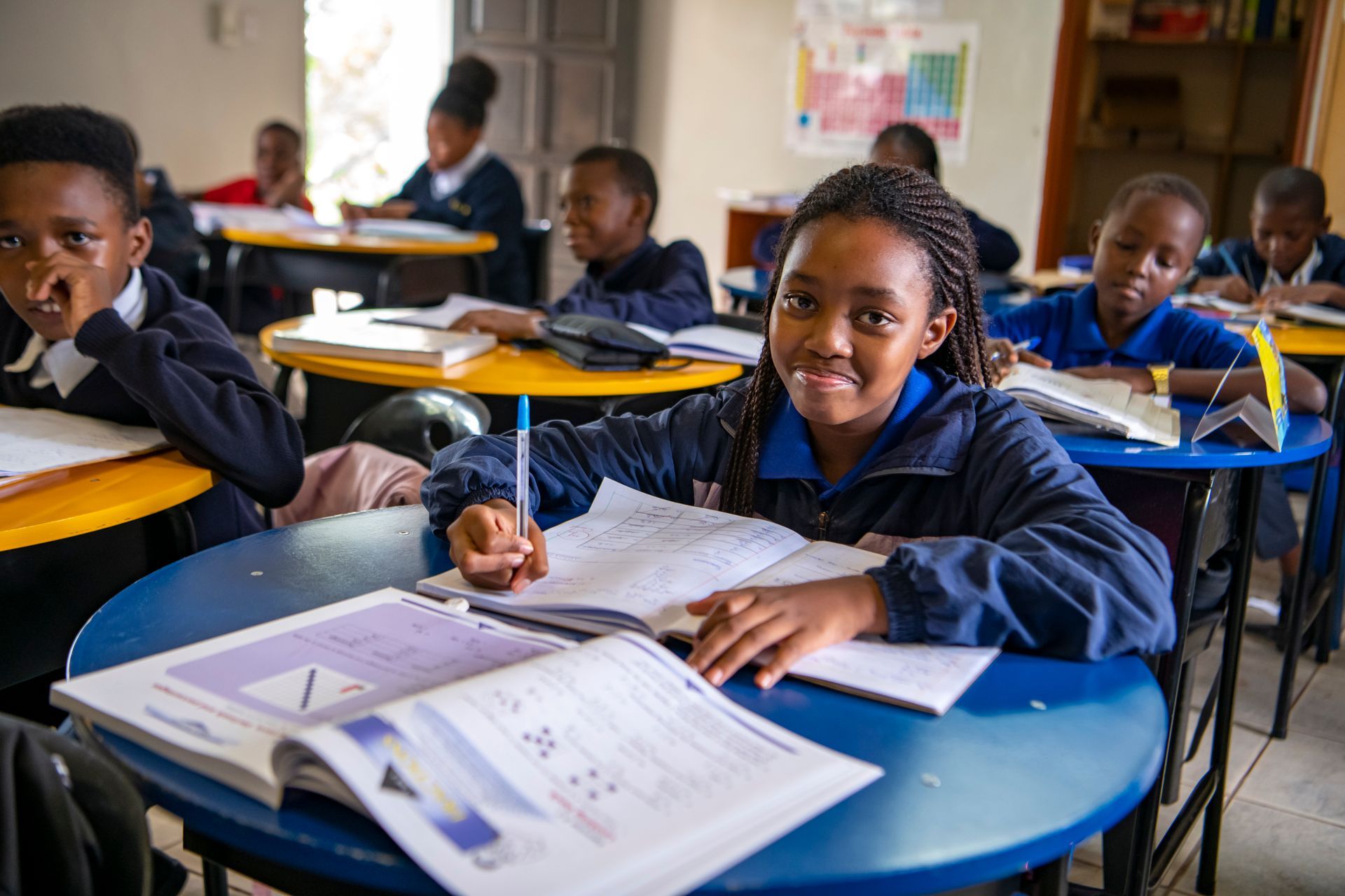 A group of children are sitting at their desks in a classroom.