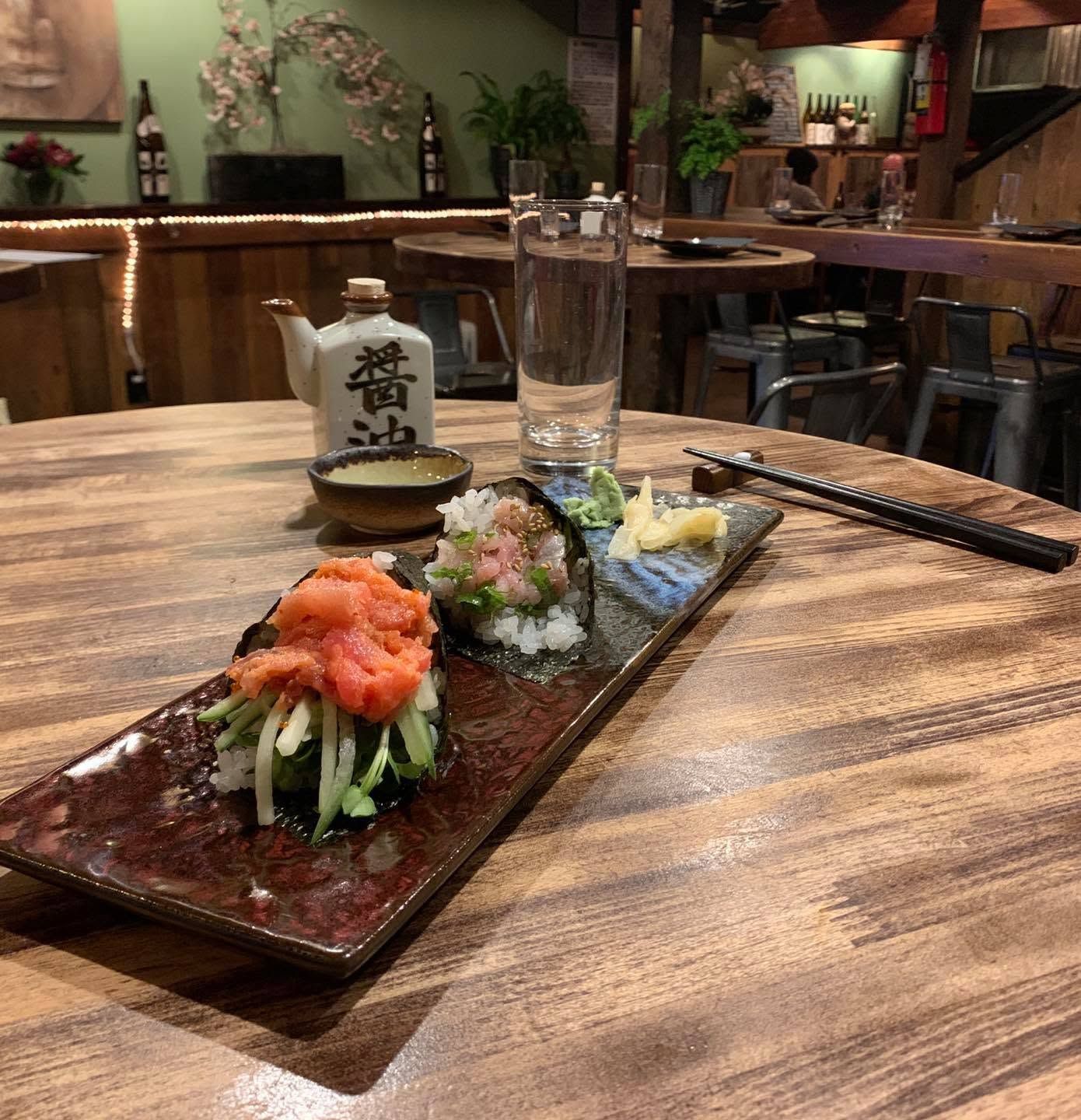 Sushi platter on a wooden table in a cozy Japanese restaurant interior