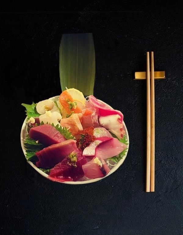 Colorful sushi bowl with chopsticks on a black background