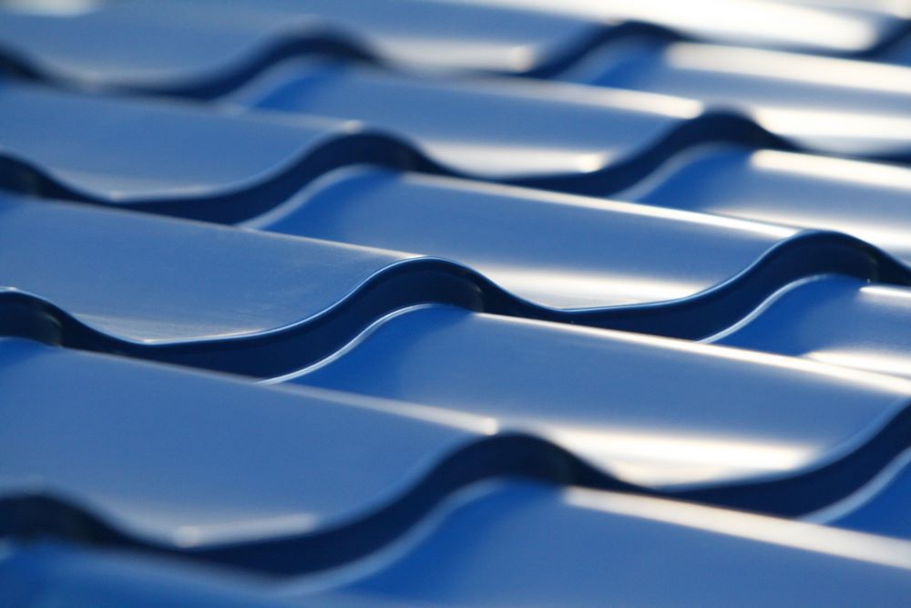 A Close Up of a Blue Roof With Waves on It — Cairns Roofing Contractors Pty Ltd in Bungalow, QLD