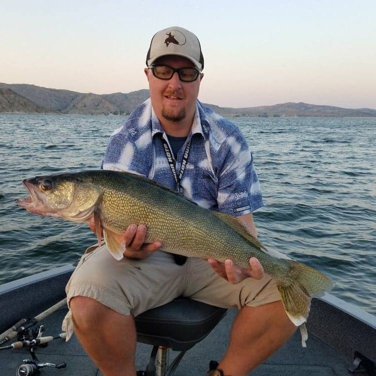 man captures walleye fish