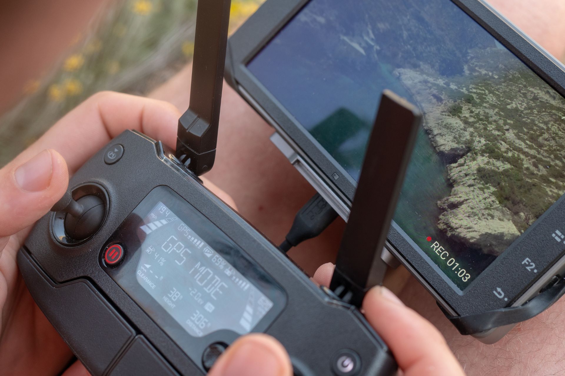 A person is using a remote control to control a drone.