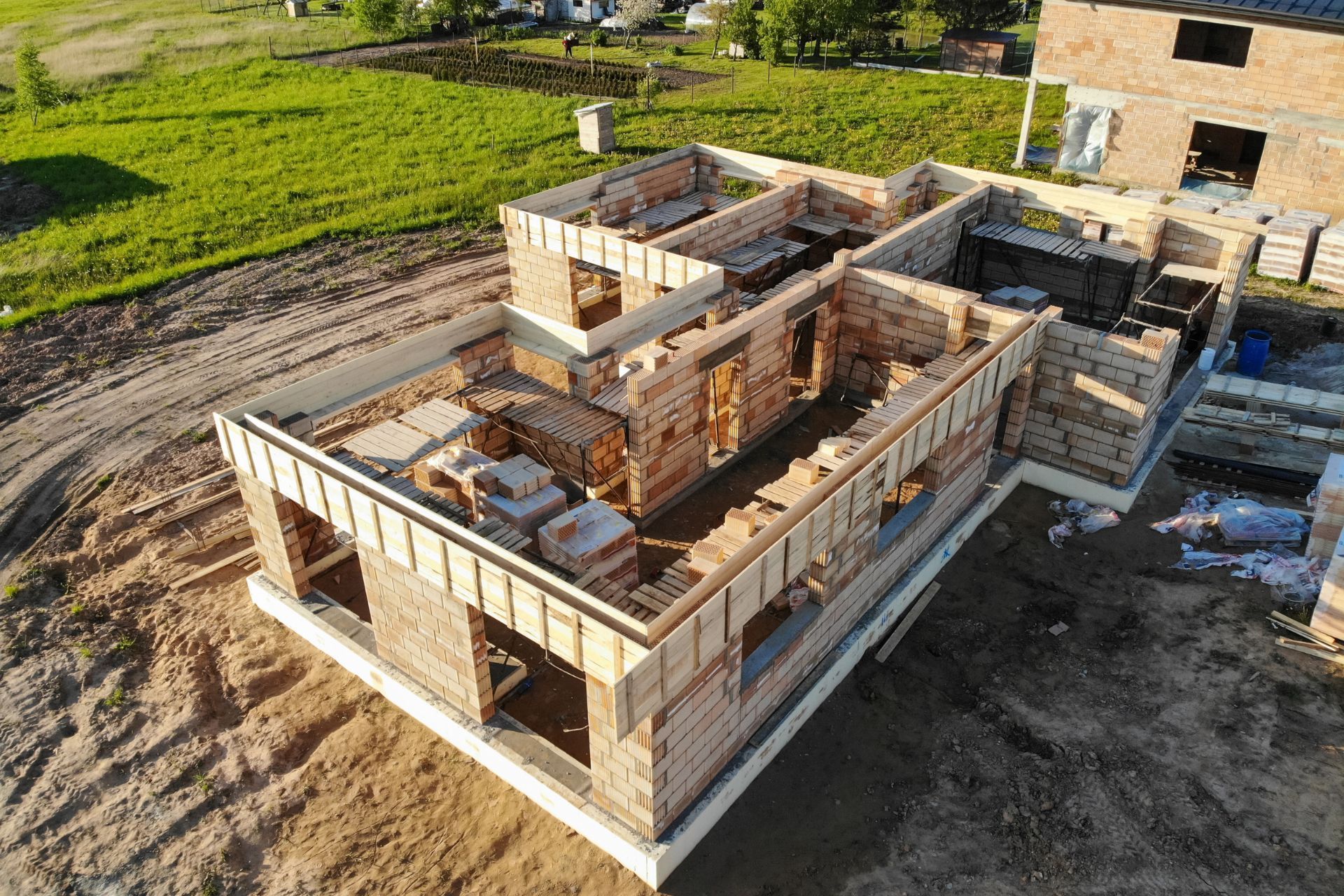 An aerial view of a drone doing construction inspection on a house under construction.