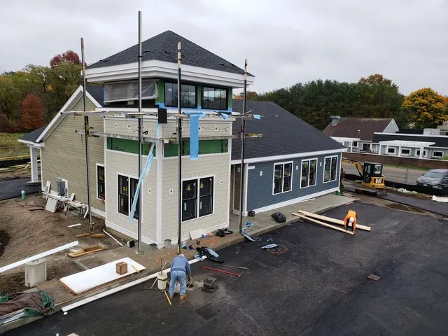 An aerial view of a building under construction on a cloudy day