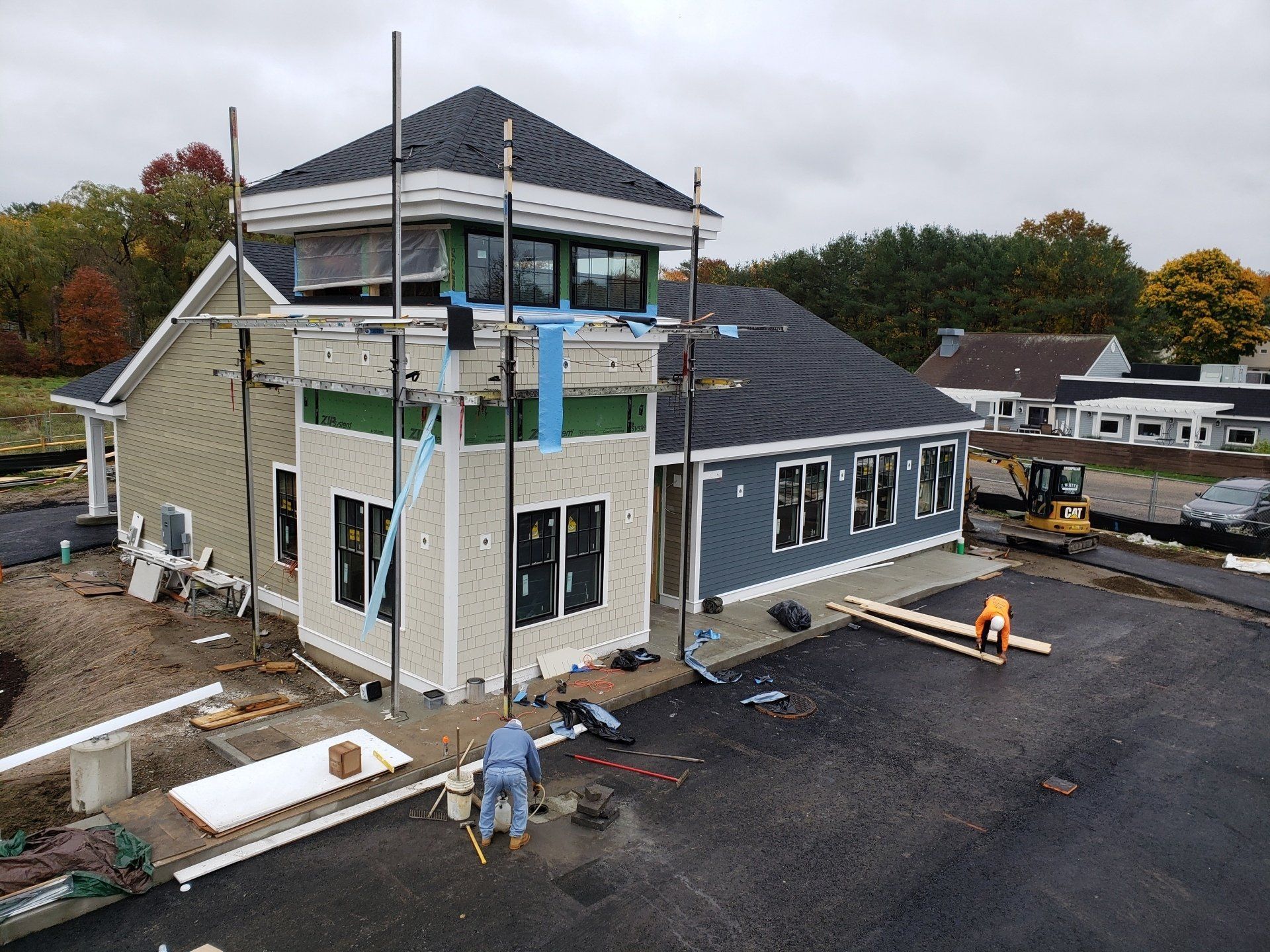 An aerial view of a building under construction on a cloudy day.