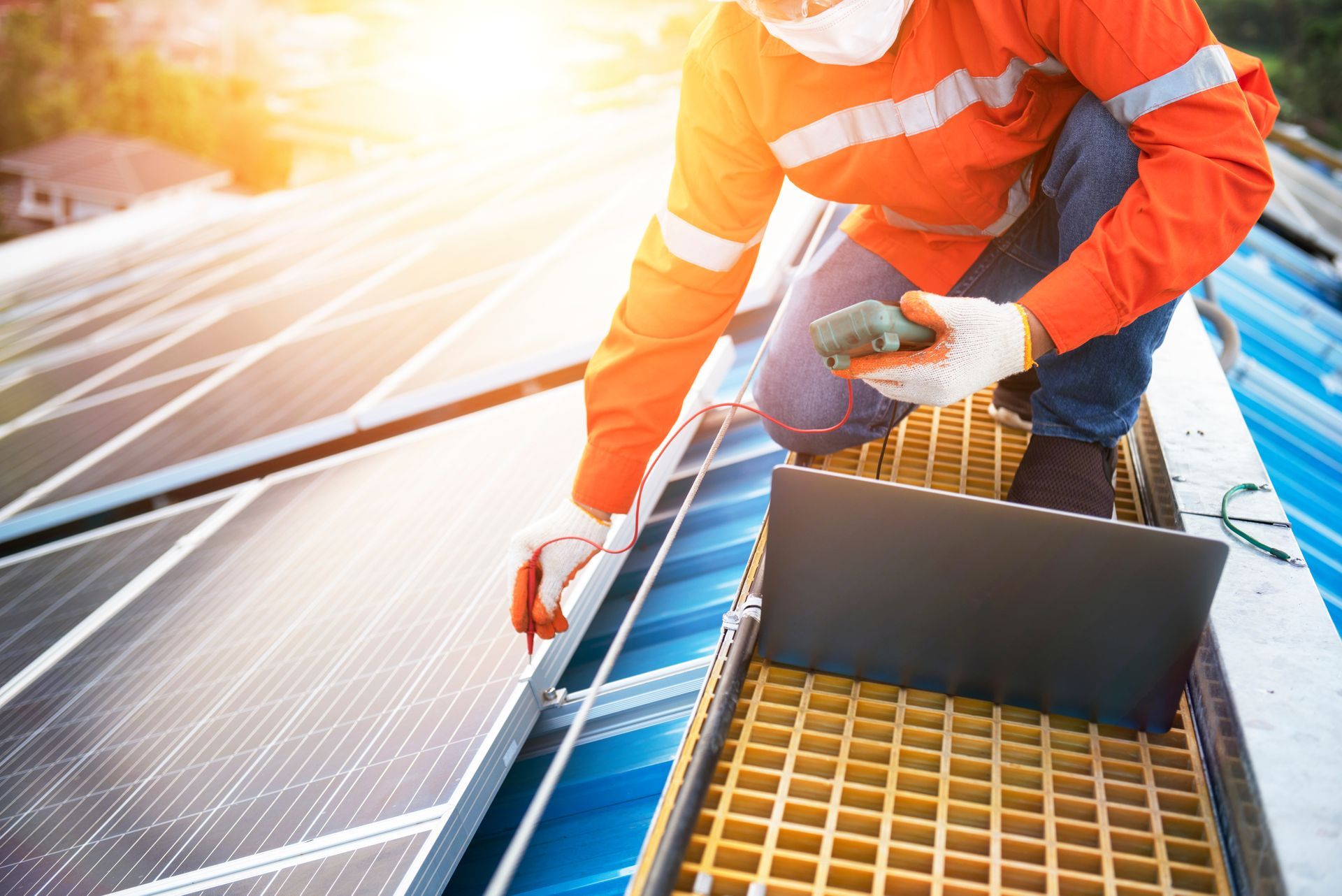 A worker repairing photovoltaic solar panels on a sunny day.