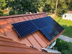 Solar panels installed on the rooftop of a charming brick house, harnessing renewable energy from the sun to power the home.