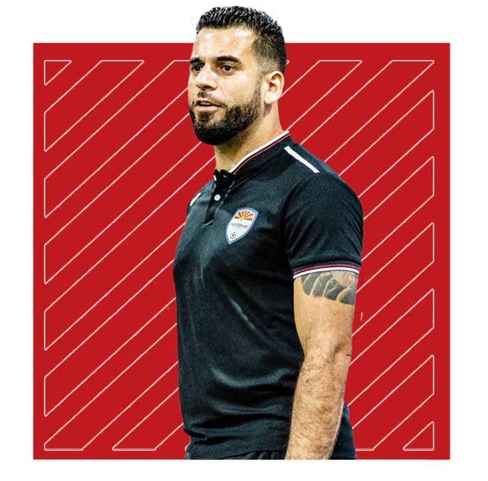 A man with a tattoo on his arm is wearing a black shirt