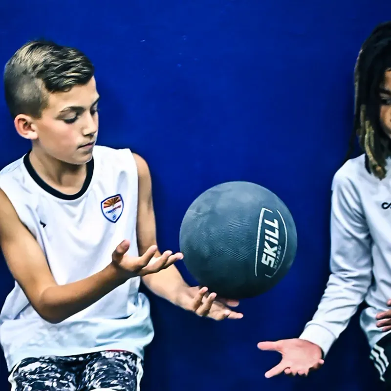 A boy and a girl are playing with a skill ball