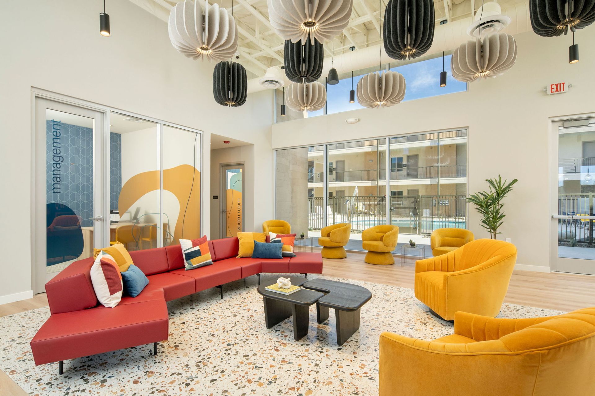 A clubhouse with a red couch and yellow chairs.