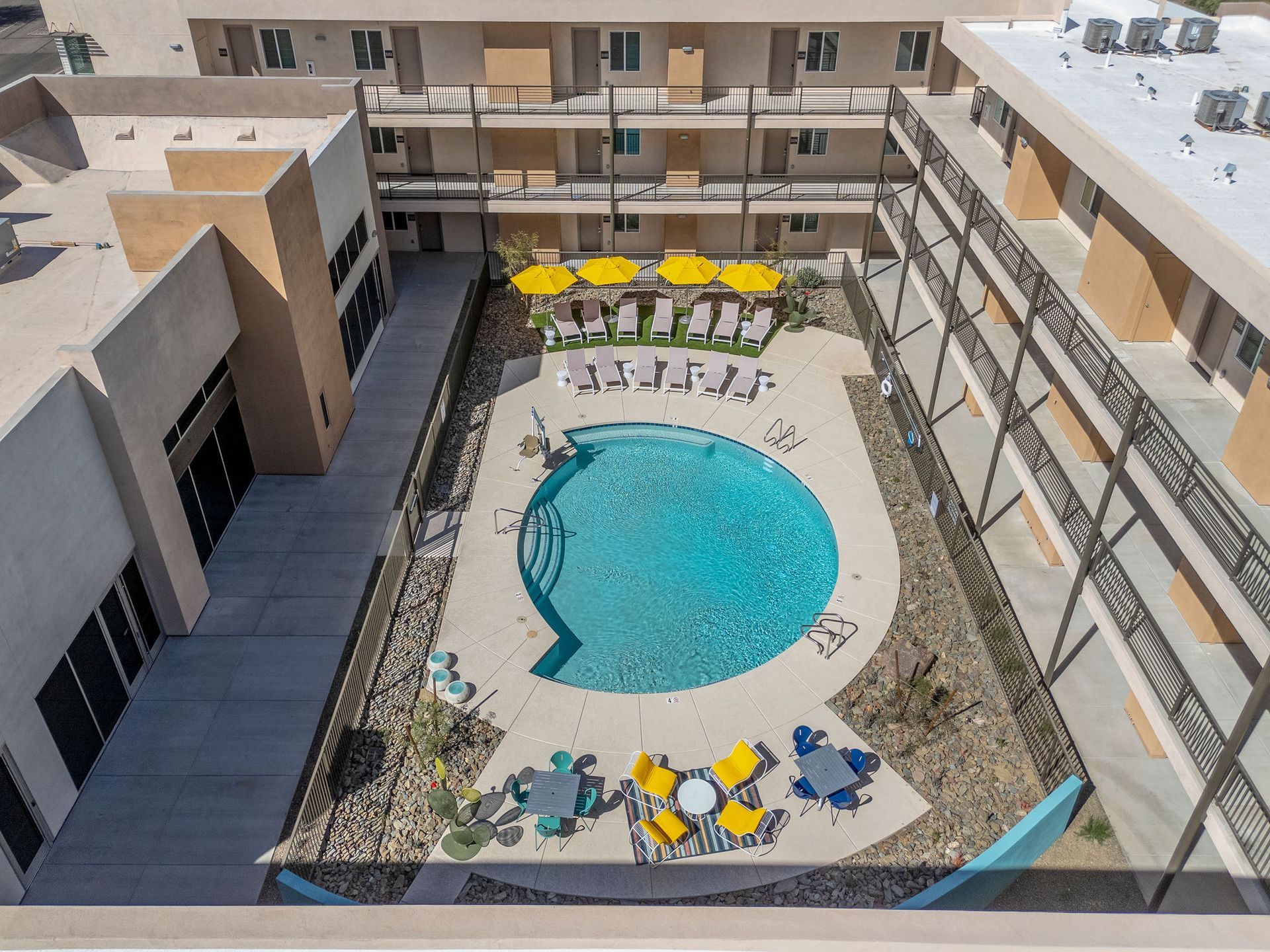 An aerial view of a large swimming pool surrounded by buildings