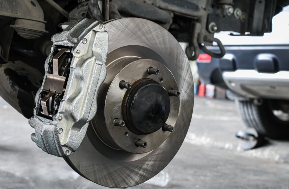 A Clean Silver Automotive Disc Brake Assembly Mounted — Morisset Automotive in Morisset, NSW