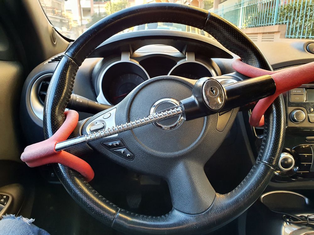 A Steering Wheel Lock with Red Handles Is Secured Across the Steering Wheel — Morisset Automotive in Morisset, NSW