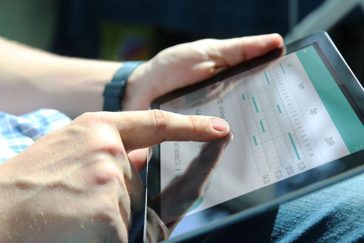 A Person Interacts with A Digital Graph on A Tablet Screen— Morisset Automotive in Morisset, NSW