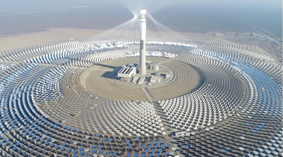 An aerial view of a large solar power plant in the desert.