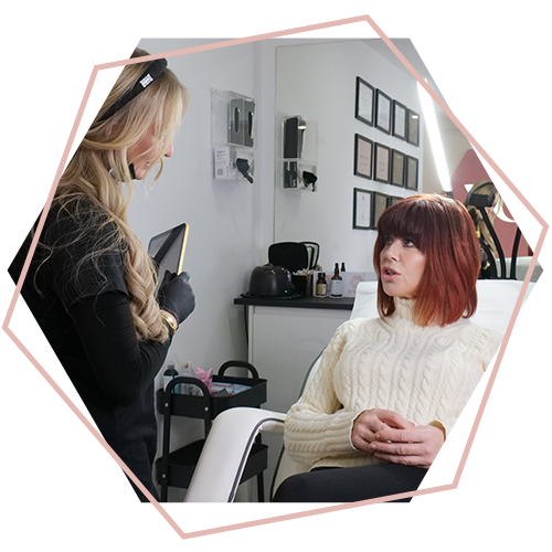 A woman is sitting in a chair talking to another woman.