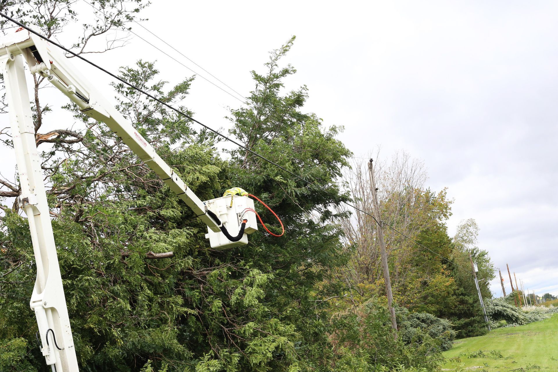 A man in a bucket is working on a power line. A man in a bucket is working on a power line.