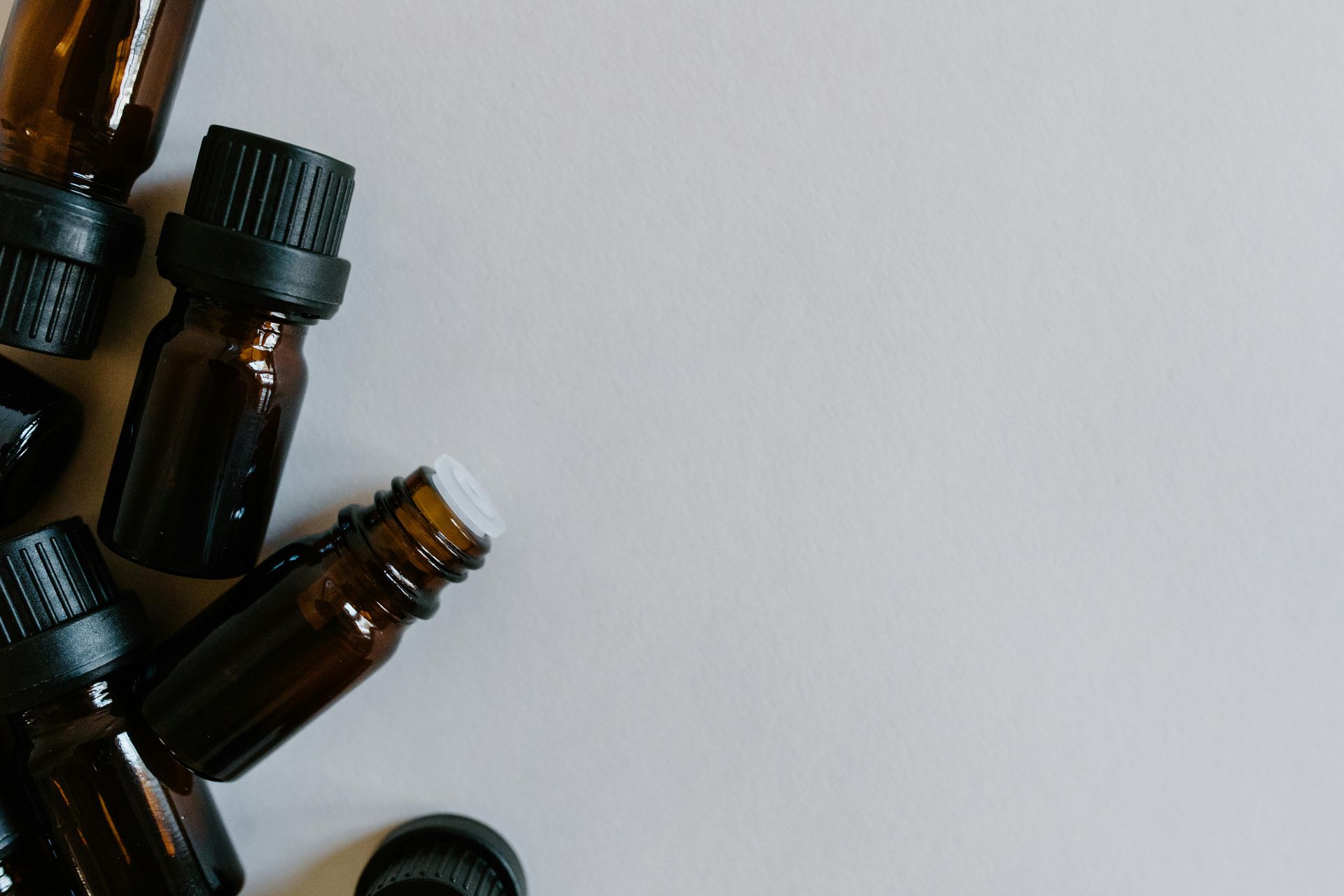 Brown essential oil bottles on a light gray background.