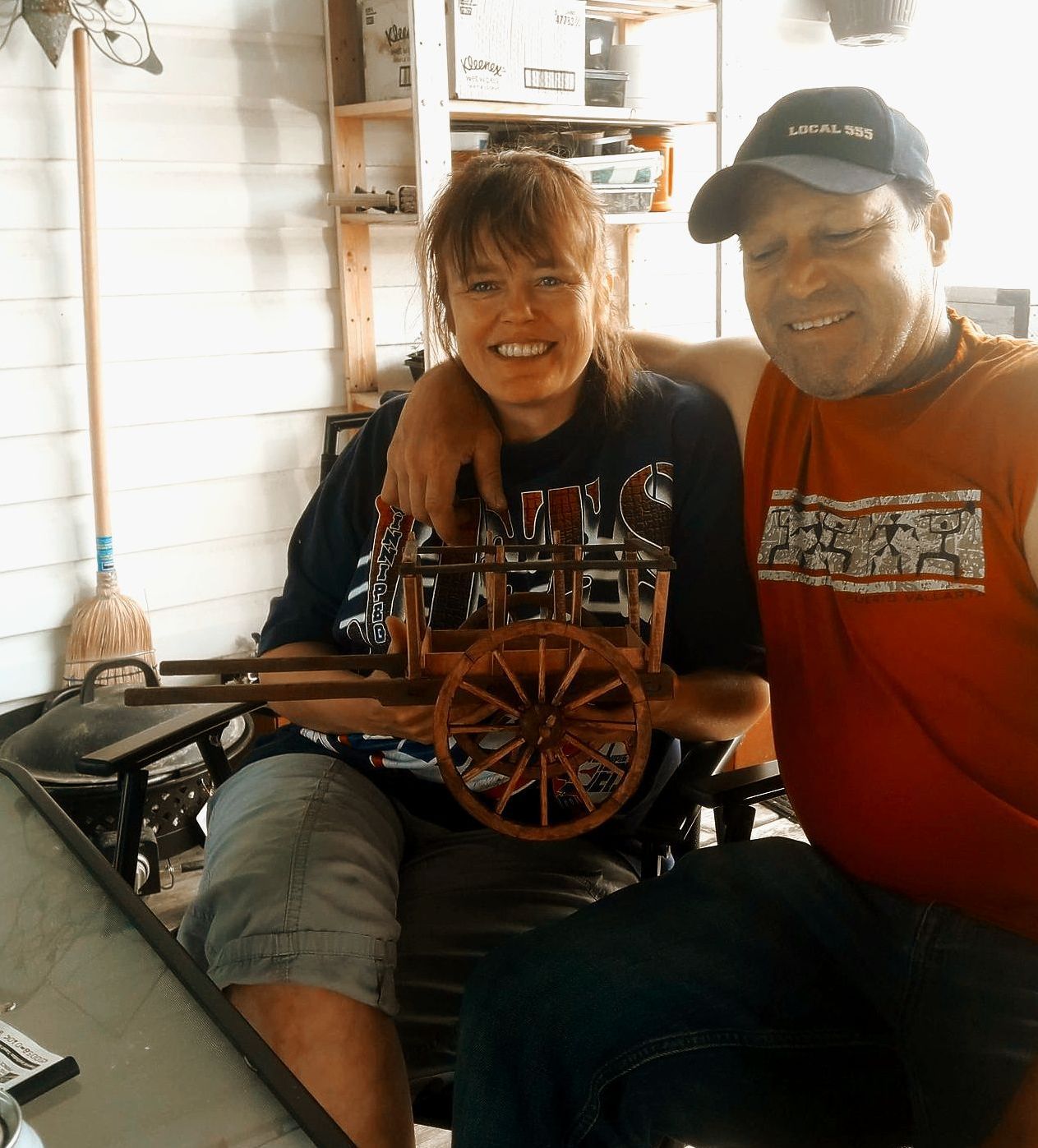 A happy couple recieving their own Red River Cart replica.