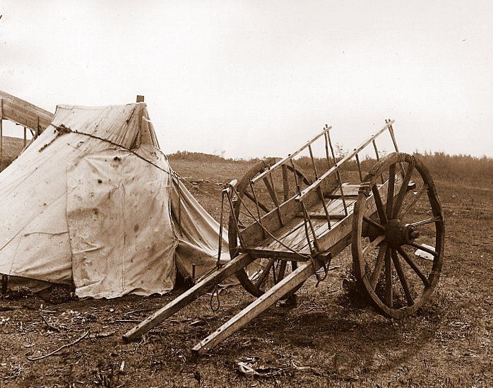 Red River Cart in front of tent on the prairies