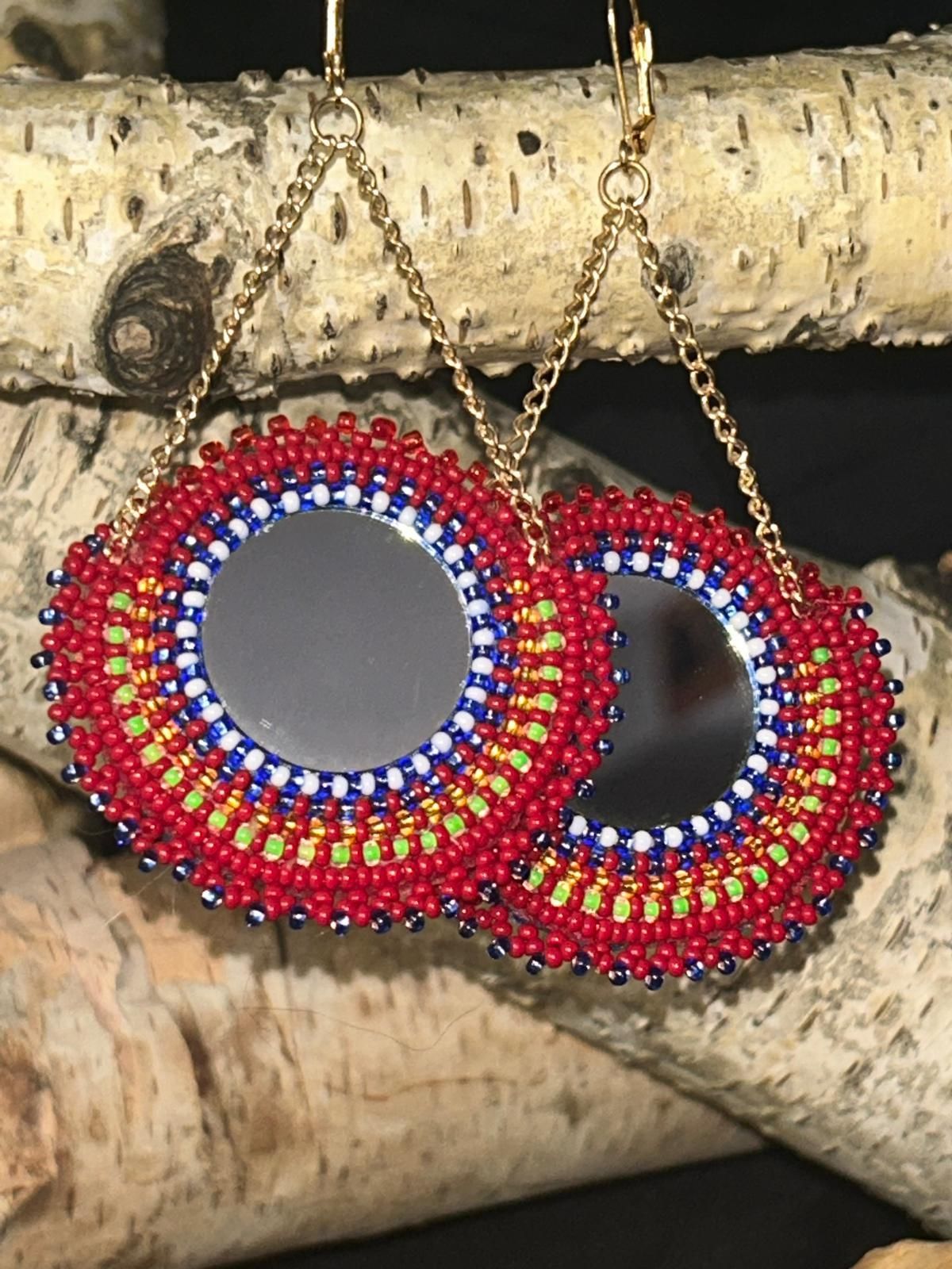 Double sided earrings with a mirror framed by a beaded Metis sash. Reverse side is orange metis floral fabric.