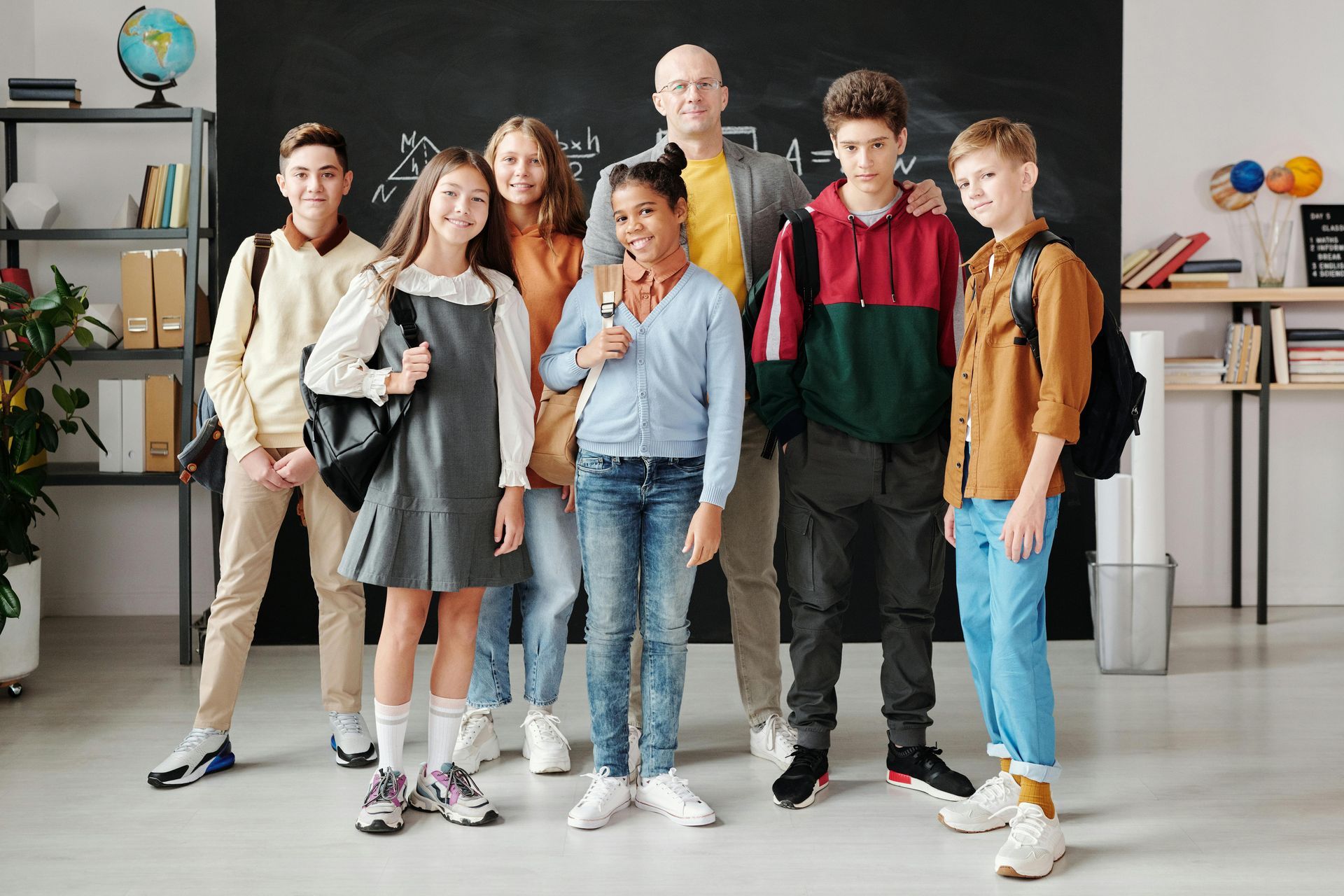 Group of students with their teacher in a classroom.
