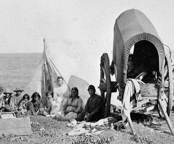 A Métis family with a Red River Cart, symbolizing cultural history