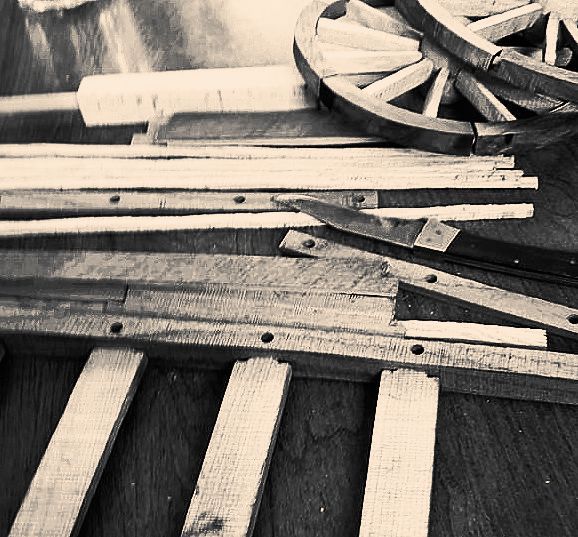 Assorted pieces of reclaimed wood being turned into pieces for the handcrafted Red River Carts