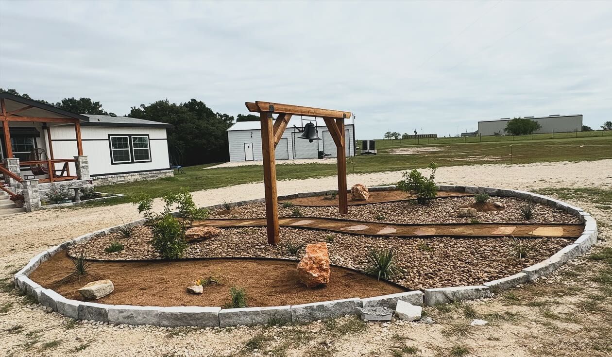 A circular garden with a wooden pergola in the middle of it.