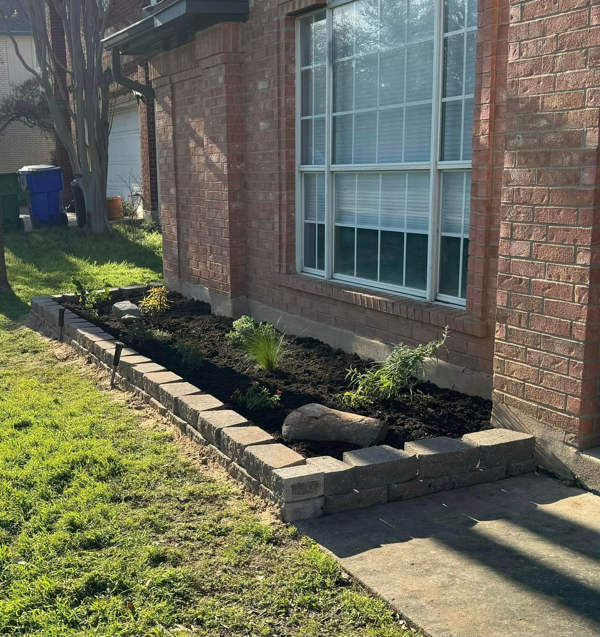 A brick house with a garden in front of it