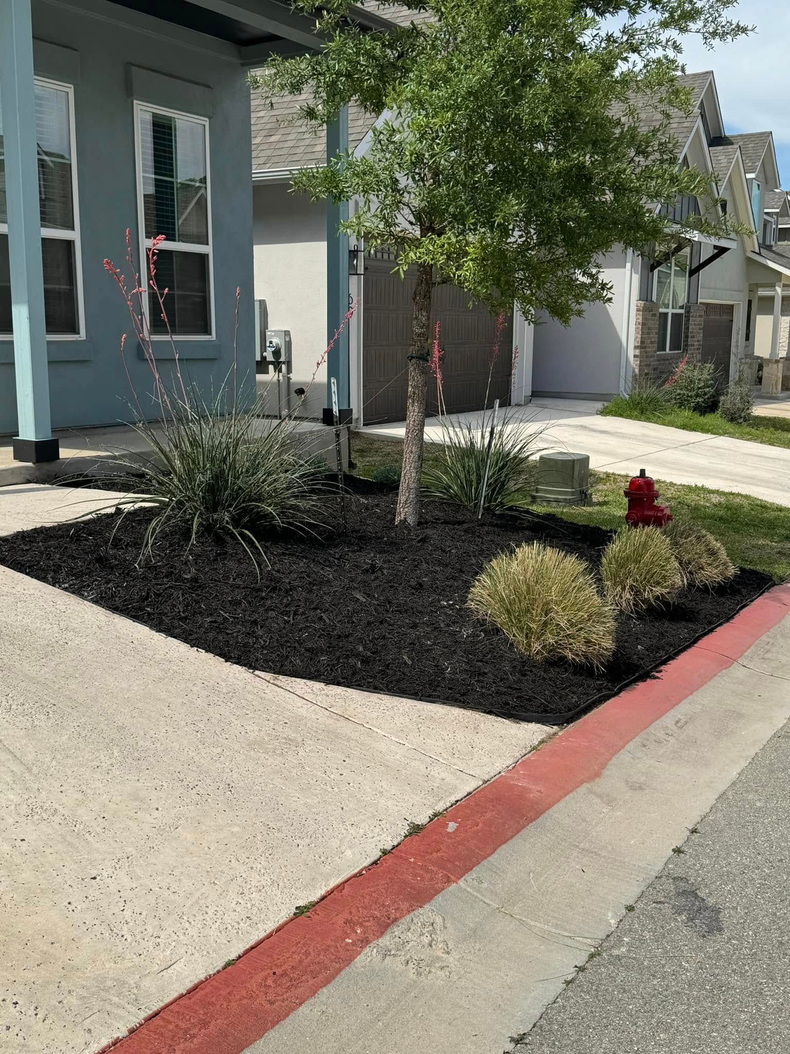 There is a fire hydrant in the middle of the driveway.