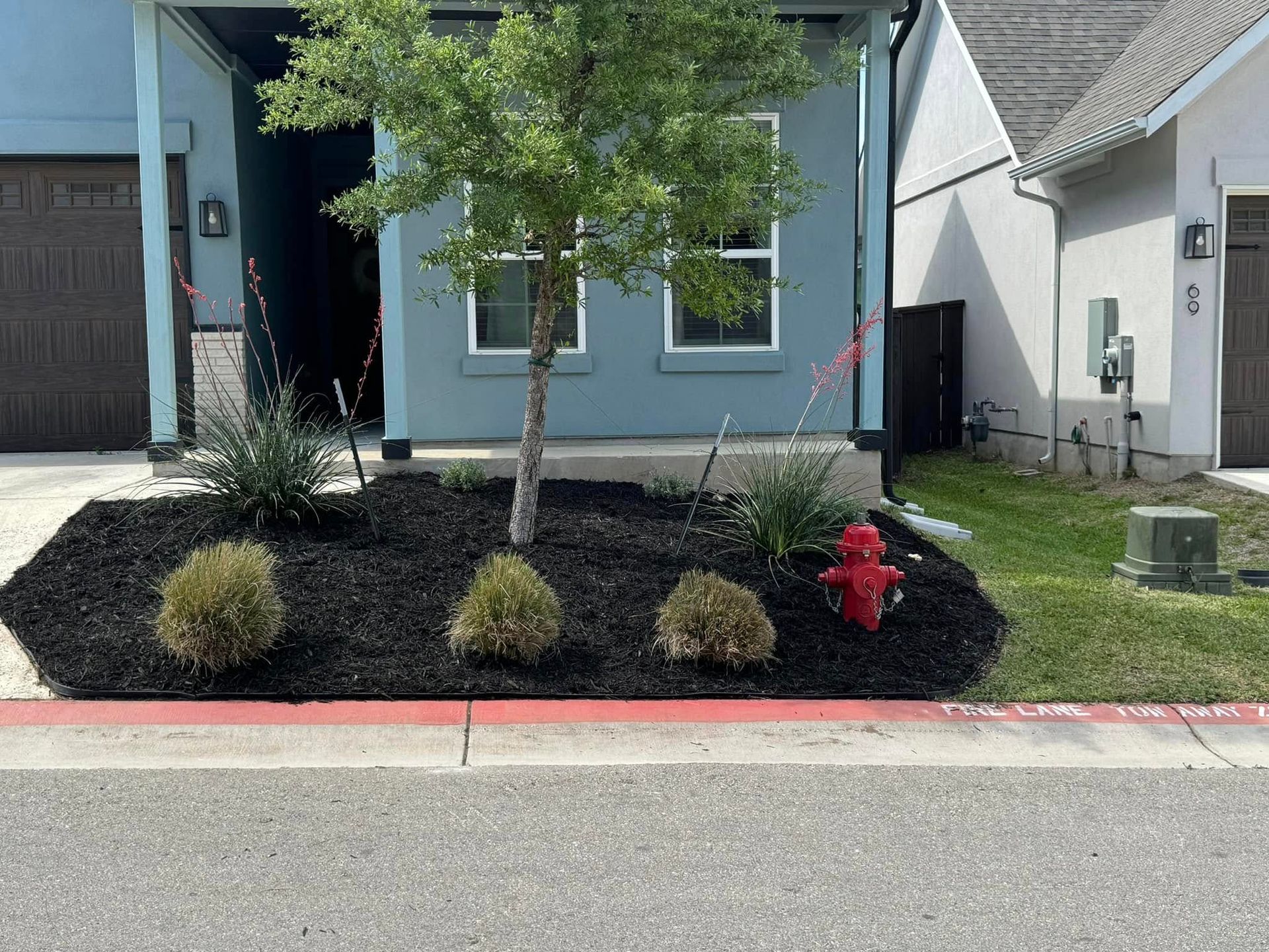 A blue house with a fire hydrant in front of it.