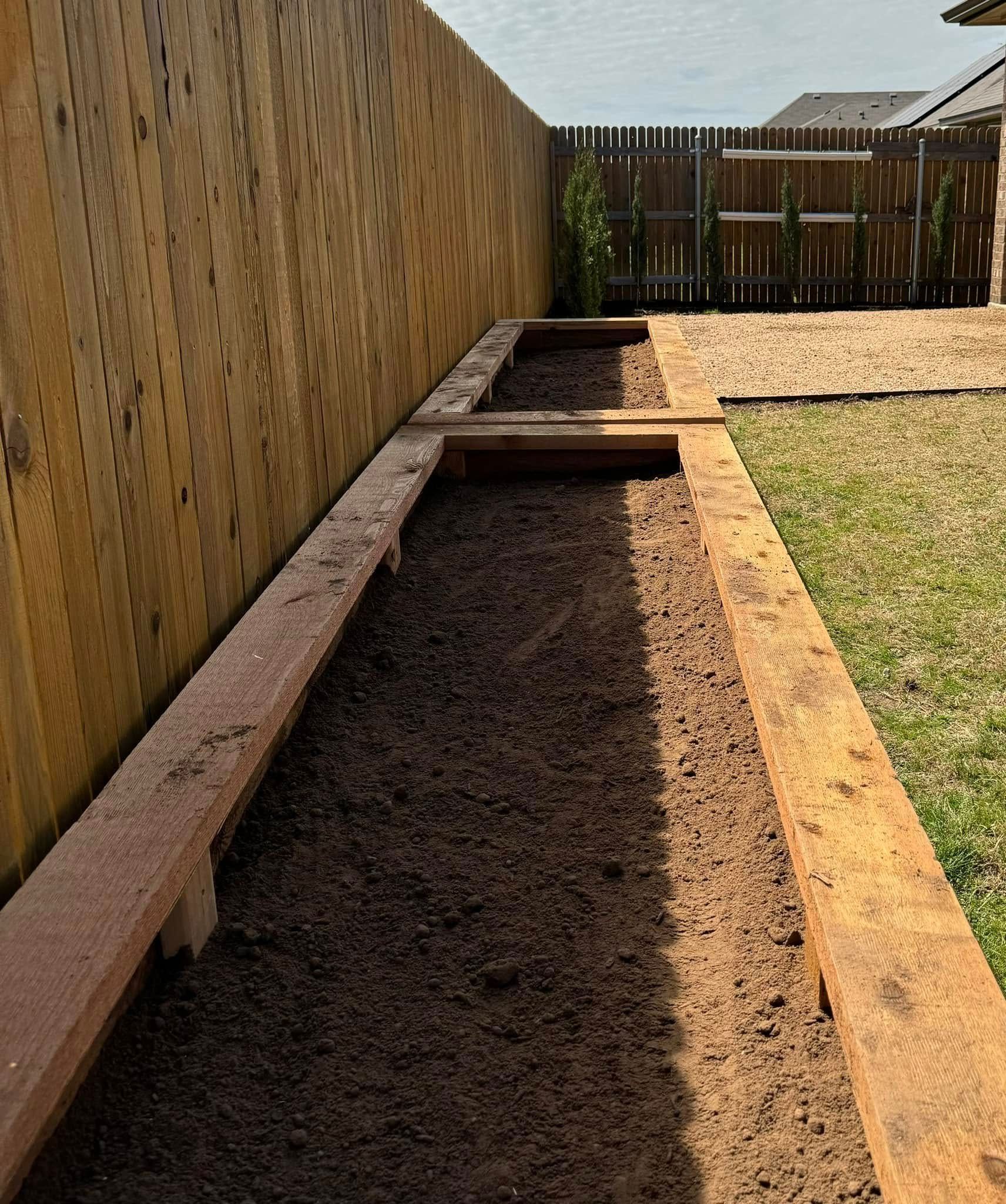 A wooden walkway with a wooden fence in the background