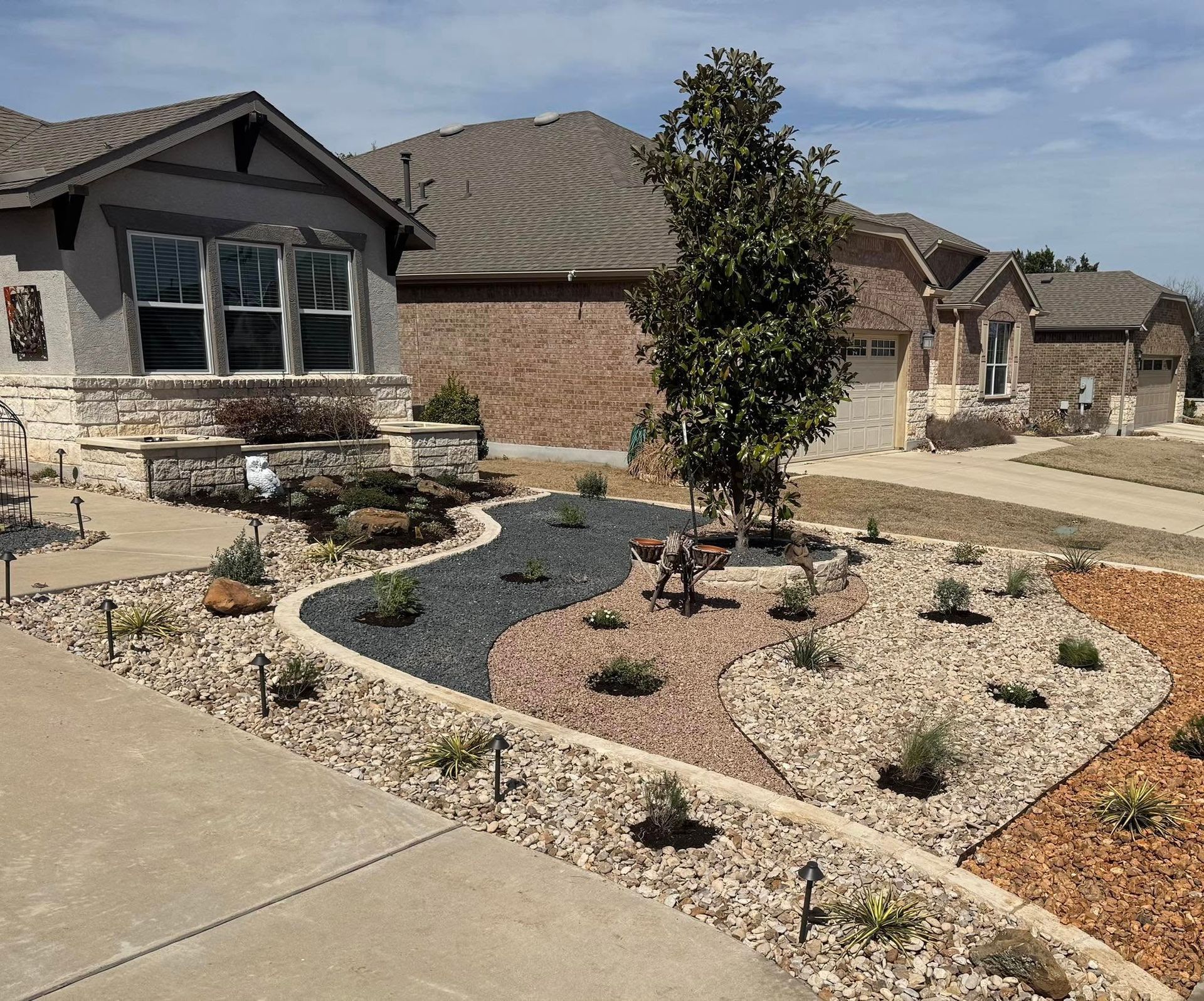 A house with a lush green garden in front of it.