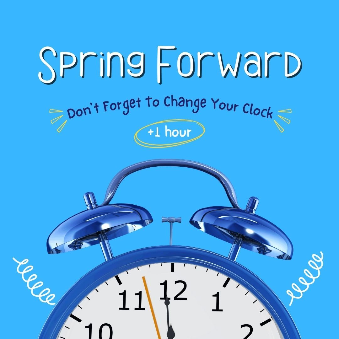 A blue alarm clock with the words spring forward on it