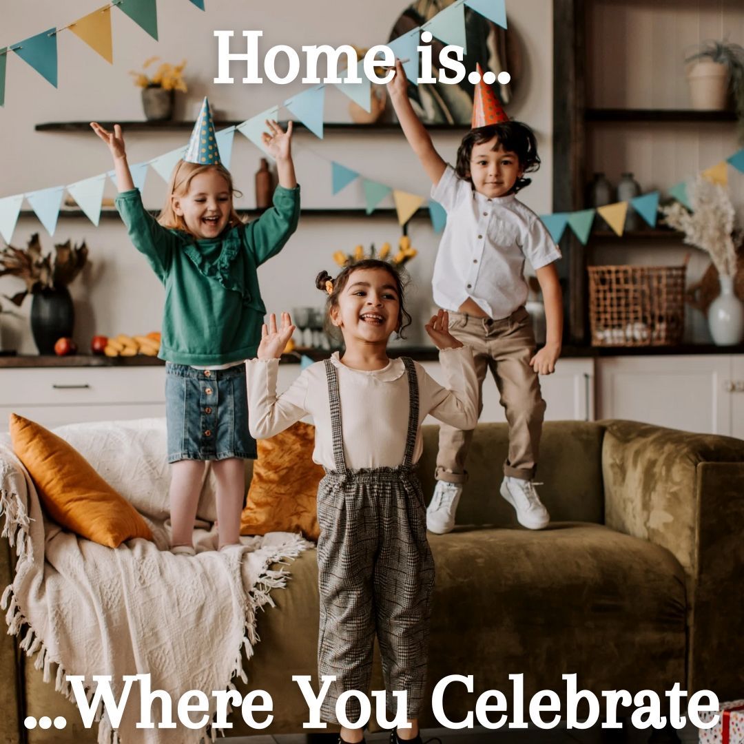 Three children are jumping on a couch in a living room.