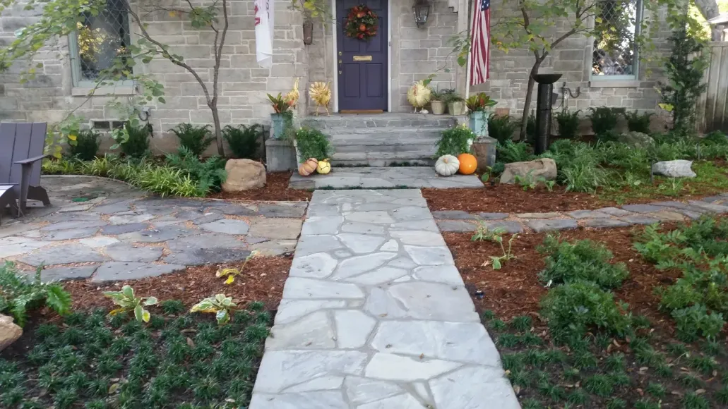 A stone walkway leading to the front door of a house.