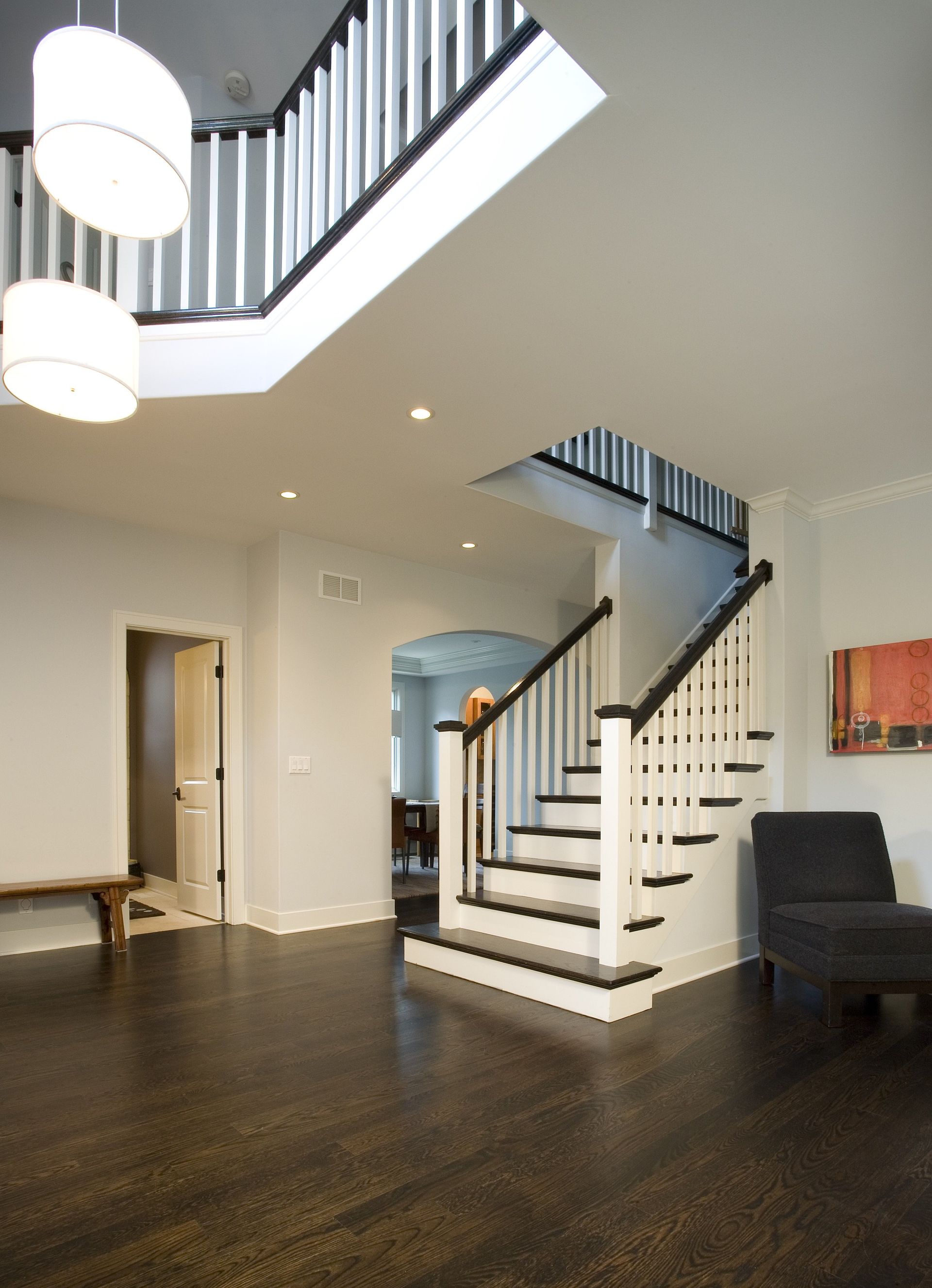 A hallway with a staircase leading up to the second floor
